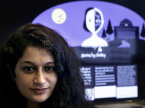 In this Tuesday, Oct. 24, 2017 photo, co-creator of a fiction-writing 'chatbot,' Massachusetts Institute of Technology postdoctoral associate Pinar Yanardag, of Istanbul, Turkey, sits for a photograph in front of a graphic from the home page of the site called "Shelley." Named after "Frankenstein" author Mary Shelley, the chatbot has been trained on more than 140,000 horror stories written by amateur writers on a popular online forum. Now Shelley is generating its own stories on Twitter, taking turns with humans in an experiment to find out if artificial intelligence is smart enough to make someone feel scared. (AP Photo/Steven Senne)