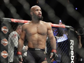 FILE - In this Saturday, Dec. 3, 2016 file photo, Demetrious Johnson reacts after defeating Tim Elliott during a mixed martial arts flyweight bout in Las Vegas. Demetrious Johnson chasing an unprecedented 11th title defense and a headline fight that could decide Conor McGregor's next opponent top a UFC 216 card set for Saturday, Oct. 7, 2017 in Las Vegas, an event playing out in a city still reeling from a mass shooting in which 58 people were killed and nearly 500 were injured. (AP Photo/John Locher, File)