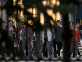 In this Aug. 31, 2017, photo, North Korean workers walk in a group to dormitories in the compound of the seafood processing factory Hunchun Pagoda in the city of Hunchun in northeastern China's Jilin province. Roughly 3,000 North Koreans are believed to work in Hunchun, a far northeast Chinese industrial hub just a few miles from the borders of both North Korea and Russia. The workers are paid a fraction of their salaries, while the rest - as much as 70 percent - is taken by North Korea's government. (AP Photo/Ng Han Guan)