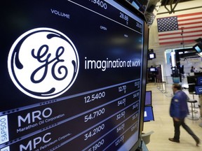 FILE - In this Monday, June 12, 2017, file photo, the General Electric logo appears above a trading post on the floor of the New York Stock Exchange. General Electric is naming Trian's Ed Garden to its board, potentially signaling a shift toward becoming a leaner, industrial player that the investment fund has been pushing for years. (AP Photo/Richard Drew, File)