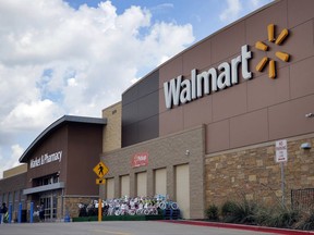 FILE - In an Aug. 26, 2016, file photo, people walk in and out of a Walmart store, in Dallas. Walmart announced new moves Monday, Oct. 9, 2017, to speed up the return process for online purchases, including letting some shoppers keep the stuff they don't want and still get a refund. (AP Photo/Tony Gutierrez, File)