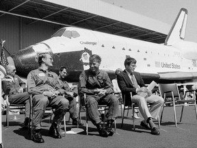 FILE - In this June 30, 1982, file photo, the new space shuttle Challenger sits behind the four astronauts that will fly it during turnover ceremonies at Rockwell International's final assembly site in Palmdale, Calif. From left: Dr. Story Musgrave, pilot Karol J. Bobko, mission specialist Donald H. Peterson and commander Paul J. Weitz. Weitz, a retired NASA astronaut who commanded the first flight of the space shuttle Challenger and flew on Skylab in the early 1970s, has died at 85. Weitz died at his retirement home in Flagstaff, Ariz., on Monday, Oct. 23, 2017, said Laura Cutchens of the Astronaut Scholarship Foundation. (AP Photo/Doug Pizac, File)