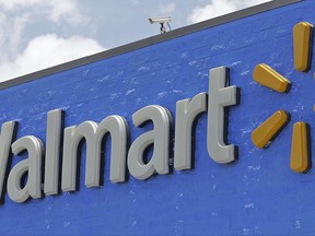 FILE - This Thursday, June 1, 2017, file photo, shows a Walmart sign at a store in Hialeah Gardens, Fla. Walmart is buying delivery company Parcel to help get groceries, other goods to customers in New York City faster. (AP Photo/Alan Diaz, File)