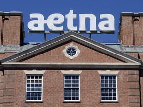 FILE - This Aug. 19, 2014, file photo, shows the corporate sign atop Aetna headquarters in Hartford, Conn. Aetna Inc. reports earnings Tuesday, Oct. 31, 2017. (AP Photo/Jessica Hill, File)