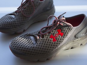 FILE - In this Monday, Jan. 4, 2016, file photo, a pair of Under Armour SpeedForm Gemini 2 Record Equipped running shoes, containing an embedded chip to track exercise, are displayed in New York. Under Armour Inc. reports earnings Tuesday, Oct. 31, 2017. (AP Photo/Mark Lennihan, File)