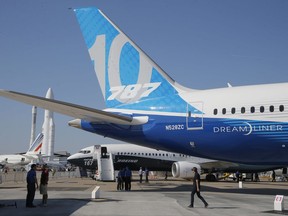 FILE -  In this Sunday, June 18, 2017, file photo, a man walks past a Boing 787-10 Dreamliner at the Paris Air Show on the eve of its opening in Le Bourget, east of Paris, France. The Boeing Co. reports earnings Wednesday, Oct. 25, 2017. (AP Photo/Michel Euler, File)