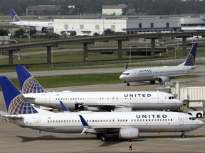 FILE - In this July 8, 2015, file photo, a United Airlines jet, front, is pushed back from a gate at George Bush Intercontinental Airport in Houston. United Continental Holdings, Inc. reports earnings Wednesday, Oct. 18, 2017. (AP Photo/David J. Phillip, File)