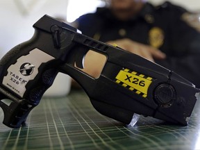 FILE - This Nov. 14, 2013, file photo, shows a Taser X26 on display. Shares in Axon Enterprises, the maker of Taser stun guns, have fallen more than 6 percent after the company admitted it had not replied to Securities and Exchange Commission inquiries due to "miscommunication issues." In a filing with the SEC on Thursday, Oct. 19, 2017, Axon said it had just become aware of the inquiries from the agency and was working to resolve the matter. (AP Photo/Michael Conroy, File)