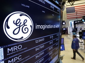 FILE - In this Monday, June 12, 2017, file photo, the General Electric logo appears above a trading post on the floor of the New York Stock Exchange. The ambition of new GE CEO John Flannery to pare away everything that could stand in the way of General Electric's return to its industrial core emerged Friday, Oct. 20, 2017, with plans to expel more than $20 billion in operations over the next couple of years. (AP Photo/Richard Drew, File)