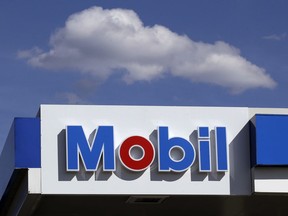 This Monday, April 24, 2017, photo shows signage at a Mobil gasoline station in Londonderry, N.H.  Exxon Mobil Corp. reports earnings Friday, Oct. 27, 2017. (AP Photo/Charles Krupa)