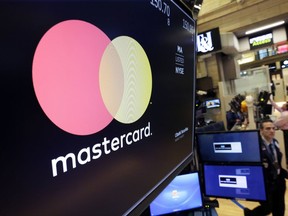 The logo for Mastercard is displayed on a screen above the trading floor of the New York Stock Exchange, Tuesday, Oct. 31, 2017. Mastercard Inc. (MA) on Tuesday reported third-quarter earnings of $1.43 billion. (AP Photo/Richard Drew)