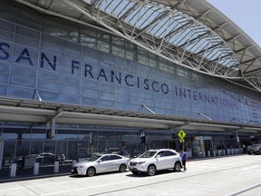 FILE - In this Tuesday, July 11, 2017, file photo, vehicles wait outside the international terminal at San Francisco International Airport in San Francisco. The Federal Aviation Authority is investigating why an Air Canada plane ignored repeated orders by an air traffic controller at San Francisco International Airport to abort a landing on Sunday, Oct. 22. The incident comes three months after another Air Canada plane nearly landed on a crowded taxiway at the airport. (AP Photo/Marcio Jose Sanchez, File)