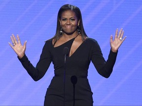 FILE - In this July 12, 2017, file photo, former first lady Michelle Obama presents the Arthur Ashe Courage Award at the ESPYS at the Microsoft Theater in Los Angeles. Obama said at a women's conference in Philadelphia on Oct. 3, 2017, that the lack of diversity among some segments of the political landscape is a reason that "people don't trust politics." (Photo by Chris Pizzello/Invision/AP, File)