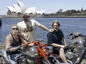 FILE - In this Feb. 15, 2007, file photo, Paul Teutul Sr. left, and sons Paul Jr. center, and Mikey from the popular reality television show "American Chopper" try out an Australian made chopper during a visit to Sydney, Australia. Discovery Channel announced on Oct. 18, 2017, it will revive the series in 2018. (AP Photo/Rob Griffith, File)