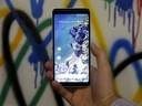 A Google employee holds up a Google Pixel 2 XL phone at a Google event