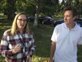In an Oct. 19, 2017 photo, Patricia Williams and her brother Robert Duffer Jr. visit a Detroit-area cemetery in Fraser, Mich., where the family buried ashes that they hope are those of their mother, Myrna Duffer. Williams said Swanson Funeral Home in Flint, in 2012, gave the family a bag of ashes that had nothing indicating they belonged to her mother. The mortuary science licenses of the funeral home and manager O'Neil Swanson II were suspended this summer after inspections found maggots on the floor of a garage where unrefrigerated bodies were being stored. (Associated Press/Corey Williams)