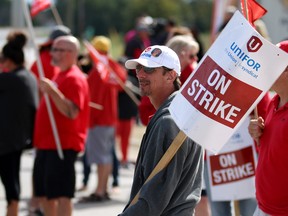 Pickets walk the line outside the strikebound Cami car factory in Ingersoll last week.