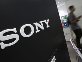 FILE - In this July 31, 2014 file photo, visitors walk past a logo of Sony at Sony Building in Tokyo. Sony Corp. is reporting its fiscal second quarter profit zoomed by 26-fold from the same period last year, boosted by the success of its image sensors, game products and the latest "Spider-Man" movie.  Tokyo-based Sony, which makes Bravia TVs, PlayStation 4 video-game consoles and Wyclef Jean recordings, reported Tuesday, Oct. 31, 2017,  a July-September profit of 130.9 billion yen ($1.2 billion), up from 4.8 billion yen reported last year. (AP Photo/Eugene Hoshiko, File)