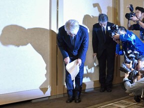 In this Oct. 13, 2017, photo, Kobe Steel's President Hiroya Kawasaki, center, bows during a press conference in Tokyo.   Japanese automakers have confirmed use of Kobe Steel products affected by fake inspection data, but say they have found no safety concerns so far.(Kyodo News via AP)