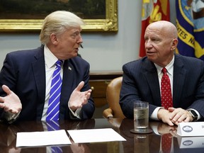In this Sept. 26, 2017 photo, Rep. Kevin Brady, R-Texas, right, listens as President Donald Trump speaks during a meeting with members of the House Ways and Means committee in the Roosevelt Room of the White House in Washington.  Brady says he's discussing the 401(k) issue with President Donald Trump, who earlier this week shot down the possibility of changes to the popular savings program.  (AP Photo/Evan Vucci)