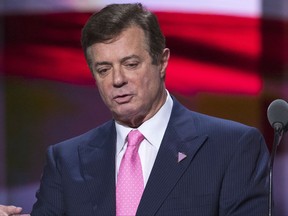 In this July 21, 2016, photo, then-campaign manager Paul Manafort for Republican presidential candidate Donald Trump stands on stage during a walk through at the Republican National Convention in Cleveland. At $7,500 apiece, Manafort's custom suits were meant to dazzle and impress, and the special counsel took notice. Court papers suggest a luxury clothing store in New York is among 19 vendors Manafort paid some $12 million using money held in foreign bank accounts he failed to disclose. He's pleaded not guilty. (AP Photo/Evan Vucci)