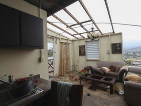 FILE - This Sept. 21, 2017 file photo shows the damaged home of Ashley Toledo's mother in the aftermath of Hurricane Maria, in Punta Diamante, Puerto Rico. Authorities warned that people in wooden or flimsy homes should find safe shelter before Maria's expected arrival. "You have to evacuate. Otherwise, you're going to die," said Hector Pesquera, the island's public safety commissioner. "I don't know how to make this any clearer." (AP Photo/Jorge A Ramirez Portela, File)