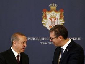 Turkey's President Recep Tayyip Erdogan, left, speaks with Serbian President Aleksandar Vucic, in Belgrade, Serbia, Tuesday, Oct. 10, 2017. Erdogan is on a two-day official visit to Serbia. (AP Photo/Darko Vojinovic)