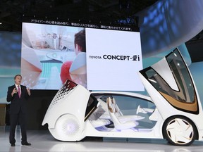Didier Leroy, executive vice president of Toyota Motor Corp., presents a Toyota Concept-i concept car during the media preview of the Tokyo Motor Show in Tokyo Wednesday, Oct. 25, 2017. (AP Photo/Eugene Hoshiko)