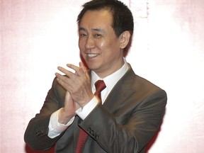 In this June 12, 2015 photo, Evergrande China founder Xu Jiayin attends a news conference for the Guangzhou Evergrande soccer team in Guangzhou in southern China's Guangdong Province. China's best known rich report released Thursday, Oct. 12, 2017, said that property tycoon Xu Jiayin has become the country's wealthiest person, knocking billionaire Wang Jianlin off the top spot. (Color China Photo via AP)