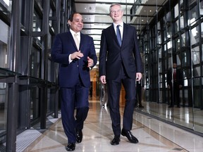Egyptian President Abdel-Fattah el-Sissi, left, and French Finance Minister Bruno Le Maire arrive for a meeting at the Finance Ministry, in Paris, Wednesday, Oct. 25, 2017. French President Emmanuel Macron offered his support Tuesday to el-Sissi in the fight against terrorism, but said that needs to be led with respect to human rights. (AP Photo/Thibault Camus)