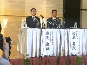 Toshiba Memory Chief Yasuo Naruke, left, and Yuji Sugimoto, head of Bain Capital, attend a press conference in Yokkaichi, central Japan, Friday, Oct. 13, 2017. The heads of Toshiba's memory chip business and Bain Capital, the investment fund buying it, said they hope to close the deal by March despite persisting opposition from Toshiba's U.S. joint venture partner Western Digital. (AP Photo/Yuri Kageyama)