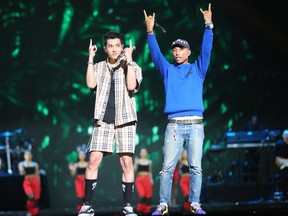 This photograph taken on November 10, 2017, shows US singer-songwriter Pharrell Williams and China's actor Wu Yifan as they perform during the 2017 Tmall 11:11 Global Shopping Festival gala in Shanghai.
