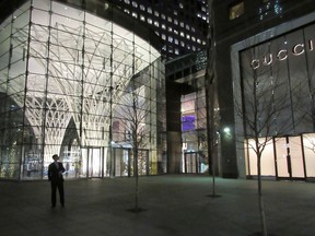 A passer-by walks past the exterior of Brookfield Place, an upscale mall in Lower Manhattan at the World Financial Center in New York. Brookfield Property is offering to buy remaining stake in mall owner GGP that it doesn’t already own for more than $14 billion.