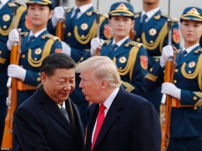 U.S. President Donald Trump, right, chats with Chinese President Xi Jinping during a welcome ceremony at the Great Hall of the People in Beijing.