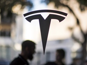 The Tesla Motors Inc. logo is displayed on a window at the company's showroom in San Francisco, California, U.S.