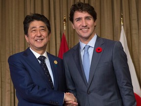 Canadian Prime Minister Justin Trudeau shakes hands with Japanese Prime Minister Shinzo Abe at the start of a bilateral meeting at the APEC Summit in Danang, Vietnam Friday November 10, 2017.