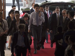 CORRECTS SPELLING OF DANANG-- Canadian Prime Minister Justin Trudeau makes his way to a meeting with Mexican President Enrique Pena Nieto at the APEC Summit in Danang, Vietnam Friday November 10, 2017. THE CANADIAN PRESS/Adrian Wyld