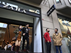 FILE - In this Friday, Nov. 3, 2017 file photo, people exit and a branch of fashion retailer Zara in an upscale Istanbul neighbourhood. Zara said Monday, Nov. 6, 2017, it is working on establishing a "hardship fund" to help a group of Turkish workers who were left unpaid when an outsource factory closed down.The workers went into Zara shops in Istanbul, leaving tags inside garments that read: "I made this item you are going to buy, but I didn't get paid for it." (AP Photo/Lefteris Pitarakis, File)
