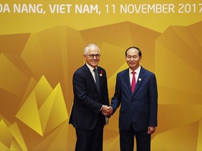 Vietnam's President Tran Dai Quang shakes hands with Australia's Prime Minister Malcolm Turnbull at the APEC Economic Leaders' Meeting in Danang, Vietnam, Saturday, Nov. 11, 2017. (Jorge Silva/Pool Photo via AP)