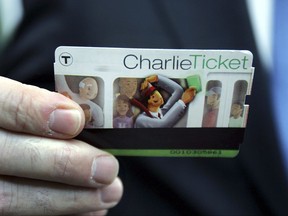 FILE - In this May 17, 2005 file photo, Massachusetts Secretary of Transportation John Cogliano shows a CharlieTicket, an automated fare card, at Airport Station in Boston. MBTA riders may soon bid farewell to the CharlieTicket and it's companion, the CharlieCard. The control board that oversees the MBTA is expected on Monday, Nov. 20, 2017, to approve a revamped fare collection system that would allow passengers to board trolleys, trains and buses with a single tap of a credit card or smartphone. (AP Photo/Chitose Suzuki, File)