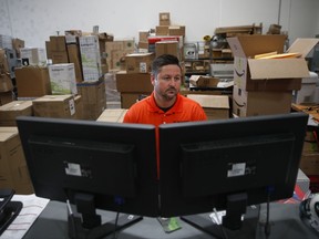 In this Wednesday, Nov. 8, 2017, photo, Ronnie DeLeo, a warehouse manager for NewAir, a manufacturing company that makes compact appliances like wine coolers and ice makers, works at his desk in Cypress, Calif. When NewAir recruits workers for its busy seasons, DeLeo tells prospective hires they have the chance to keep their jobs when the sales surge is over. While they're working, they'll compete for permanent jobs with NewAir's existing staff. (AP Photo/Jae C. Hong)