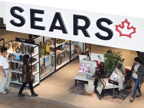 Shoppers enter and leave a Sears retail store in Toronto on Thursday, October 19, 2017. Consumers who add extended warranties to their big purchases may be seeking peace of mind, but in reality they're allowing retailers to subsidize consumers who don't buy the extra coverage, says a warranty expert. THE CANADIAN PRESS/Nathan Denette