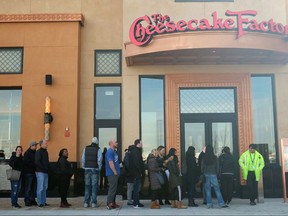 People stand line for the opening of a new Cheesecake Factory restaurant at Yorkdale shopping centre in Toronto on Tuesday Nov. 21, 2017. This is the first Cheesecake Factory location in Canada. THE CANADIAN PRESS/Giordano Ciampini