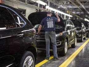 New Ford Edges sit on a production line as Ford Motor Company celebrates the global production start of the 2015 Ford Edge at the Ford Assembly Plant in Oakville, Ont., on Thursday, February 26, 2015. The Canadian and Mexican governments are pressing the U.S. explain its auto proposal at the current round of NAFTA talks.