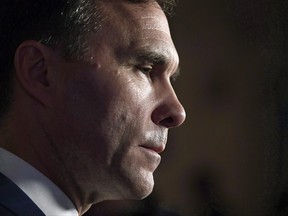 Minister of Finance Bill Morneau listens to a question as he speaks to reporters in the Foyer of the House of Commons on Parliament Hill following Question Period, in Ottawa on Oct. 26, 2017. THE CANADIAN PRESS/Justin Tang