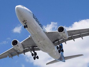 An Air Transat Airbus A330 lands at Montreal's Trudeau Airport, Sunday, July 31, 2016. A federal agency is ordering Air Transat to cover out-of-pocket expenses for passengers caught in an hours-long tarmac delay this summer as part of a ruling that lays blame solely for the fiasco on the airline.