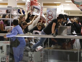 Shoppers rush to grab electric griddles and slow cookers on sale for $8 shortly after the doors opened at a J.C. Penney story in Las Vegas on November 23, 2012. Chaotic images of people clamouring to be the first through the doors to get their hands on hot deals have become synonymous with Black Friday in recent years. However, the one-day shopping frenzy at malls and stores following American Thanksgiving may be on the decline as some consumers and retailers start to shun the tradition by either opting out entirely or turning to internet shopping instead. THE CANADIAN PRESS/AP, Julie Jacobson