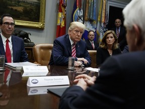 President Donald Trump listens during a meeting on tax policy with business leaders in the Roosevelt Room of the White House, Tuesday, Oct. 31, 2017, in Washington. From left, Treasury Secretary Steve Mnuchin, Trump, Karen Kerrigan, President and CEO, Small Business & Entrepreneurship Council, and Tom Donohue, President and CEO, U.S. Chamber of Commerce, foreground. (AP Photo/Evan Vucci)