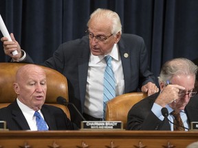 Rep. Bill Pascrell, D-N.J., center, confers with House Ways and Means Committee Chairman Kevin Brady, R-Texas, joined by Rep. Richard Neal, D-Mass., the ranking member, at right, as the GOP tax bill debate begins to wrap, on Capitol Hill in Washington, Thursday, Nov. 9, 2017. (AP Photo/J. Scott Applewhite)