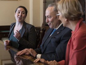 From left, Leandra English, who was elevated to interim director of the Consumer Financial Protection Bureau by its outgoing director, meets with Senate Minority Leader Chuck Schumer, D-N.Y., and Sen. Elizabeth Warren, D-Mass., to discuss the fight for control of the U.S. consumer watchdog's fate after President Donald Trump chose White House budget director Mick Mulvaney for the same post, on Capitol Hill in Washington, Monday, Nov. 27, 2017. (AP Photo/J. Scott Applewhite)